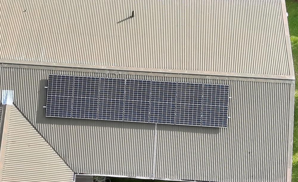 Colour drone photo of a roof with solar panels